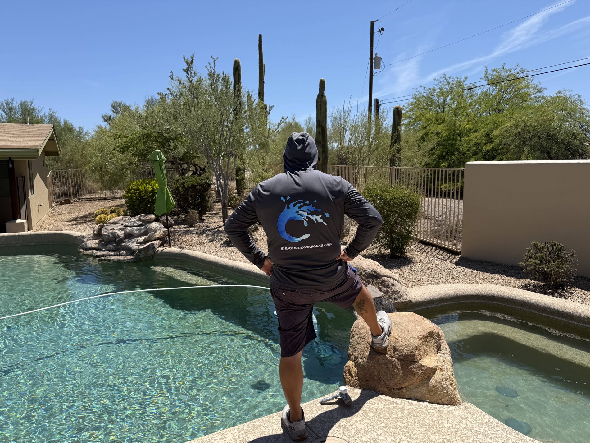 Steve McCool standing at the edge of a pool he services in the Arizona desert